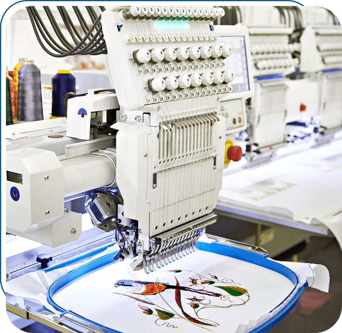 Embroidery machine stitching colorful bird design.