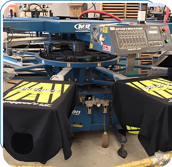Screen printing machine with custom black and yellow shirts.