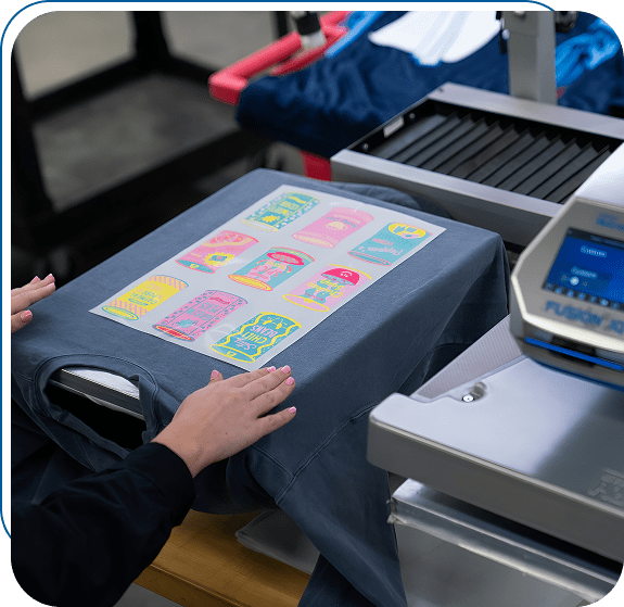 Person using a heat press machine with a colorful design on fabric.