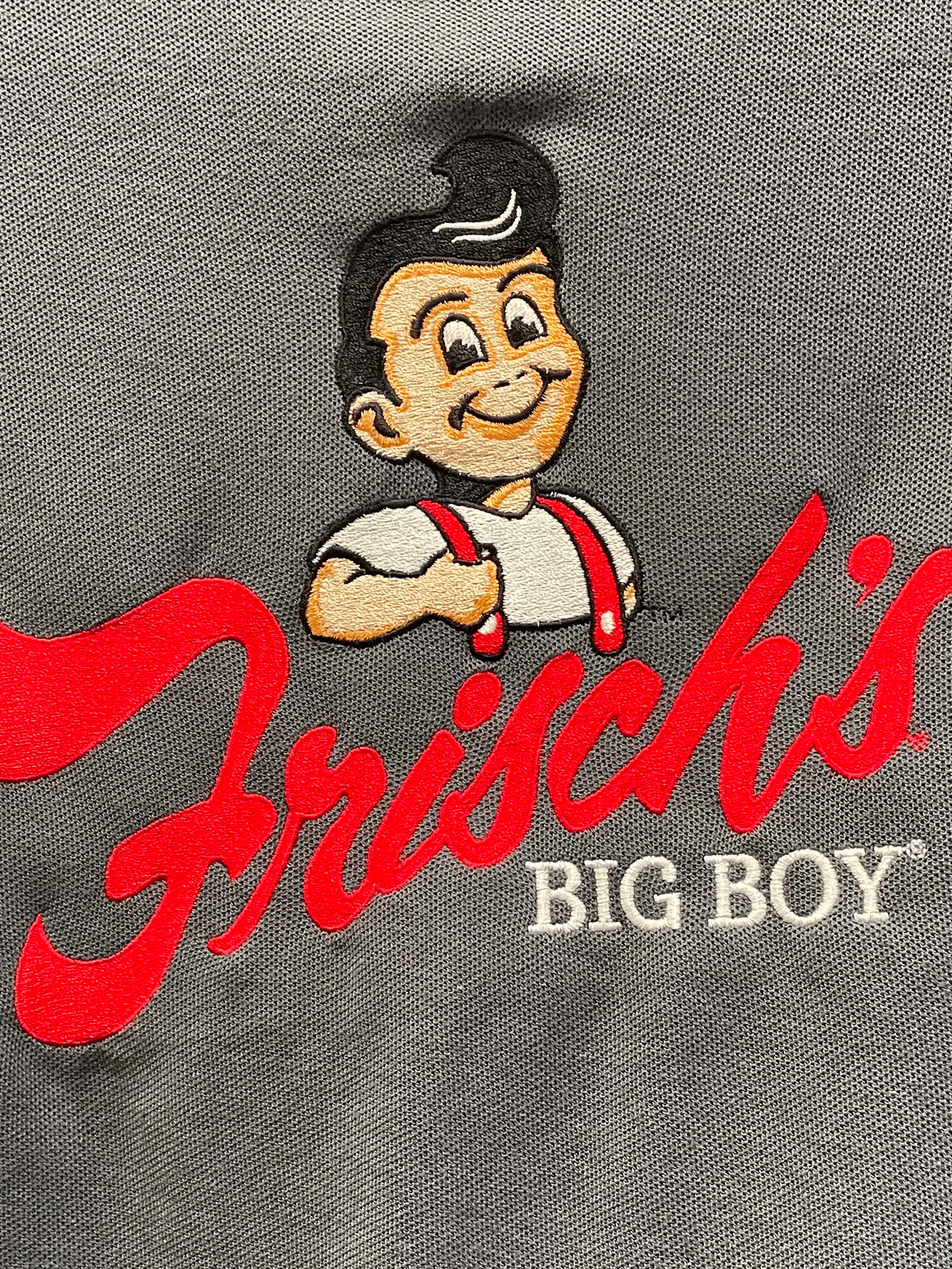 Logo of Frisch's Big Boy with a cartoon boy mascot.